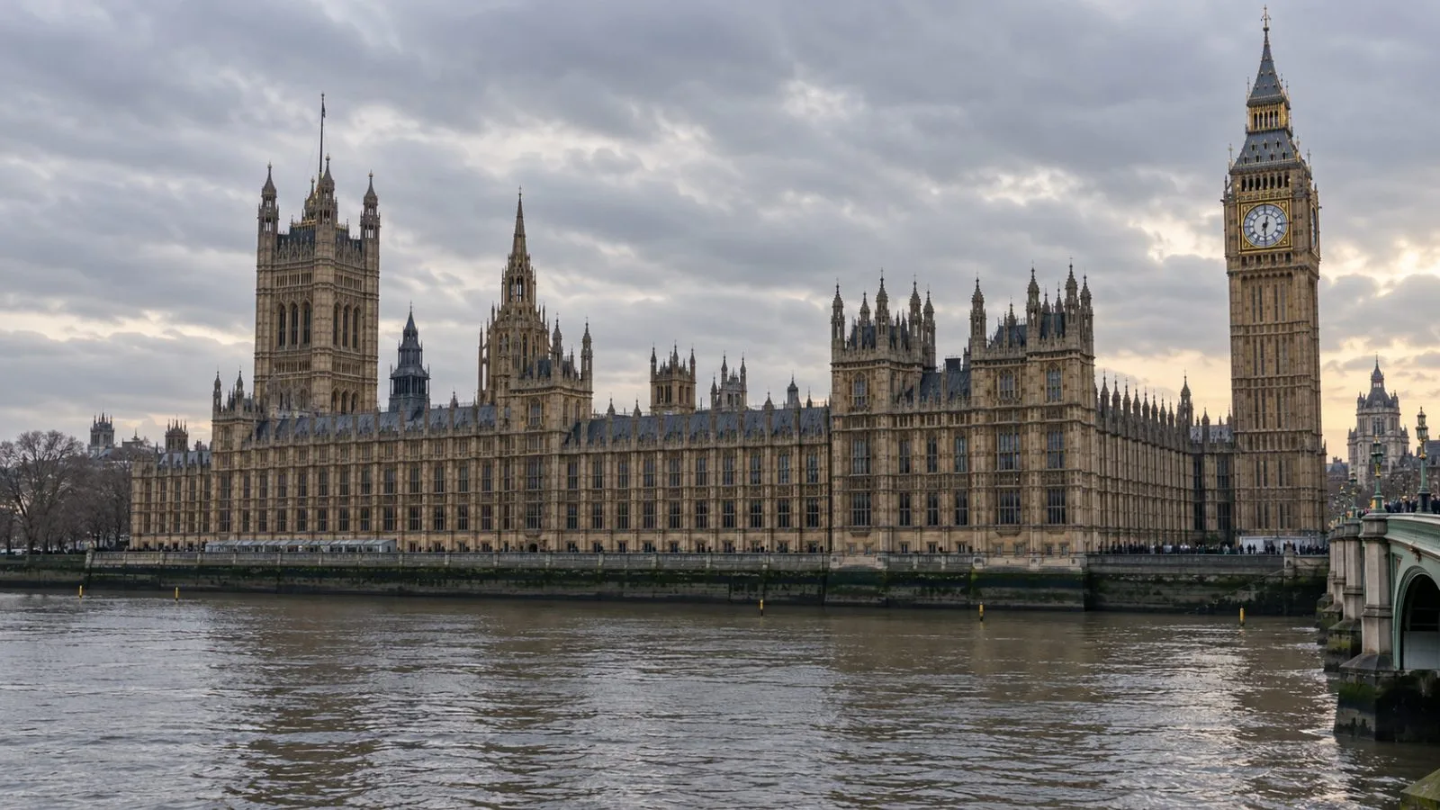 The Palace of Westminster stands beside the River Thames in London under an overcast sky. (AI-generated image / EconoTimes)