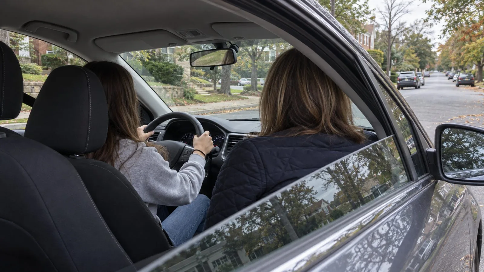 A teen practices driving with an adult passenger on a residential street in Arlington, Virginia / EconoTimes.ai
