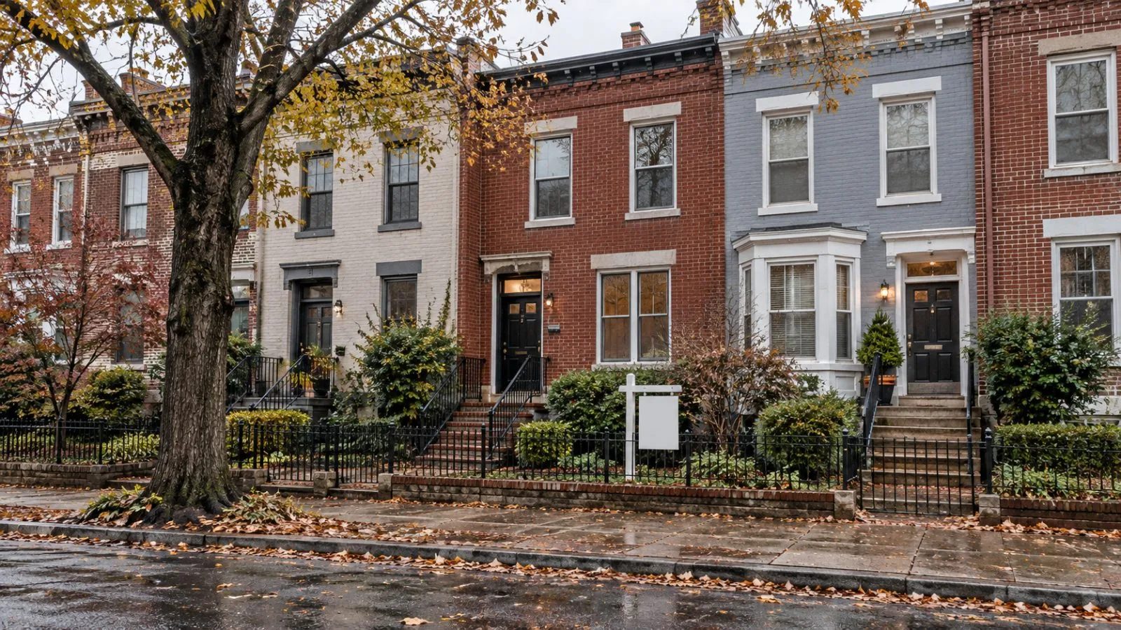 A row house with a real estate sign stands along a Washington, D.C., residential street. / EconoTimes.ai