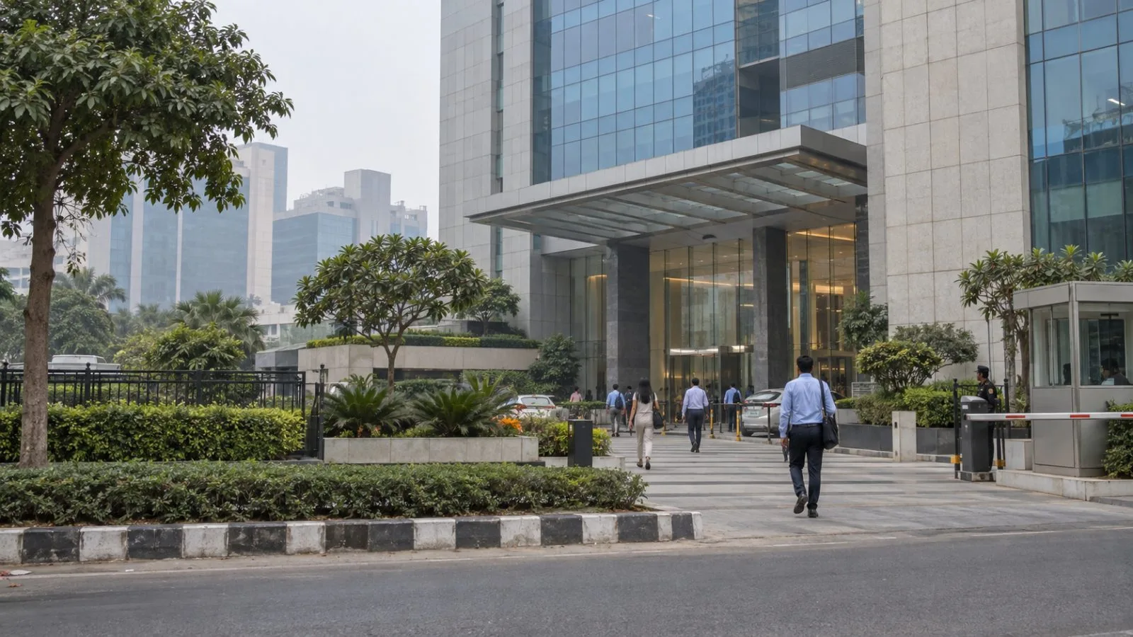 Office workers pass Unitech Commercial Tower in Gurugram, Haryana, on an overcast morning. (AI-generated image / EconoTimes)