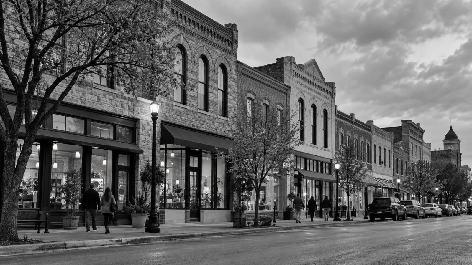 Pedestrians pass brick storefronts along a quiet block in downtown McKinney, Texas. (AI-generated image / EconoTimes)