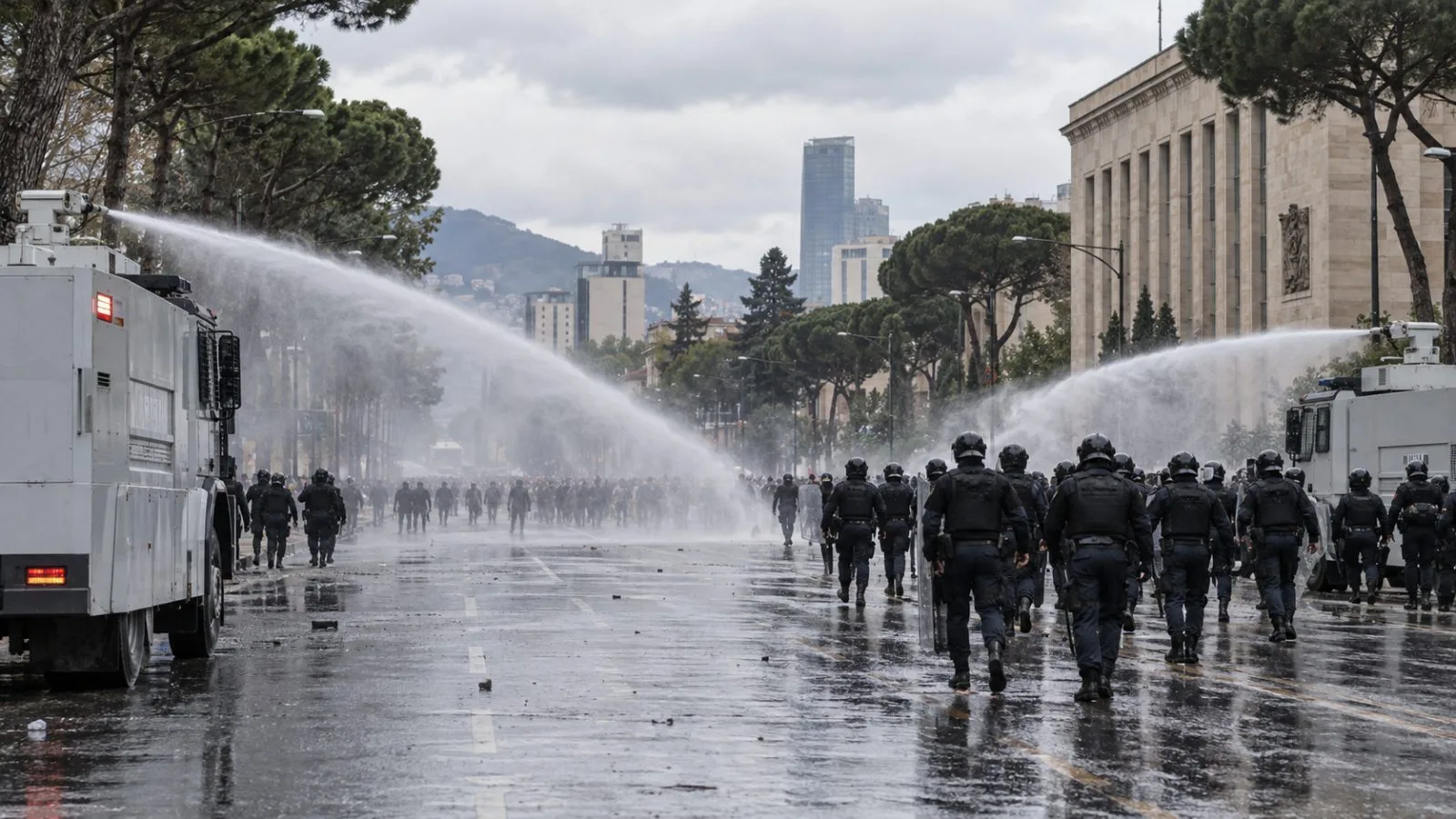 Water-cannon trucks spray water on Bulevardi Dëshmorët e Kombit in Tirana, Albania (AI-generated image / EconoTimes)