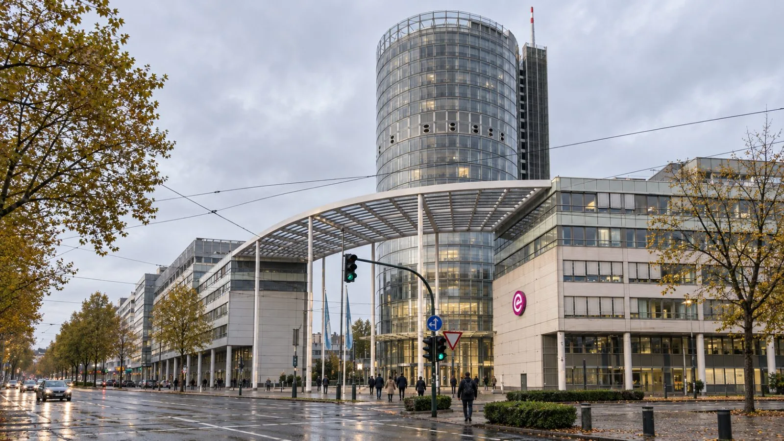Pedestrians cross Opernplatz outside Evonik Tower in Essen, Germany, on an overcast morning. / EconoTimes.ai