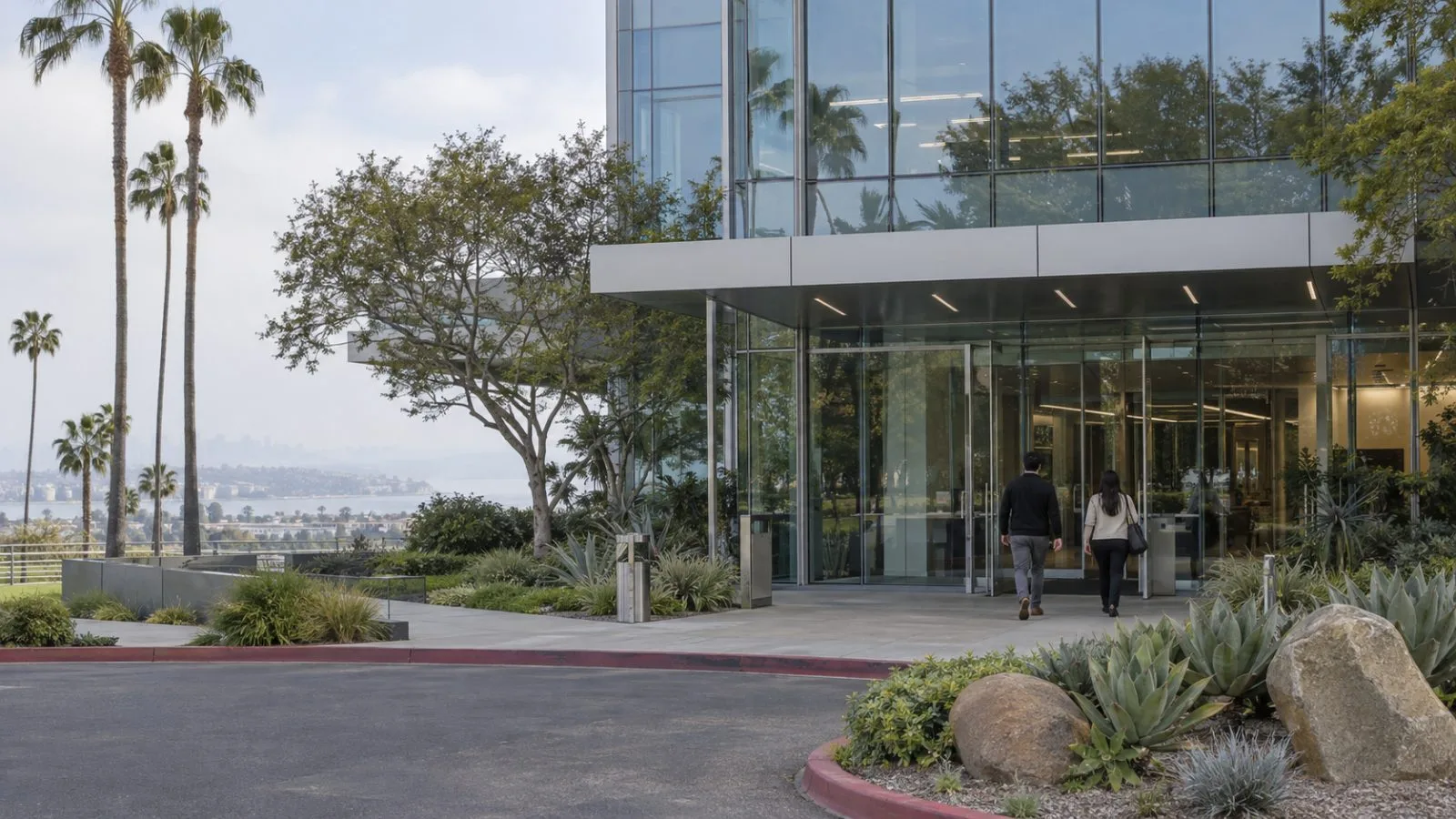 Two employees enter QuidelOrtho’s headquarters in San Diego, California, on an overcast morning. (AI-generated image / EconoTimes)
