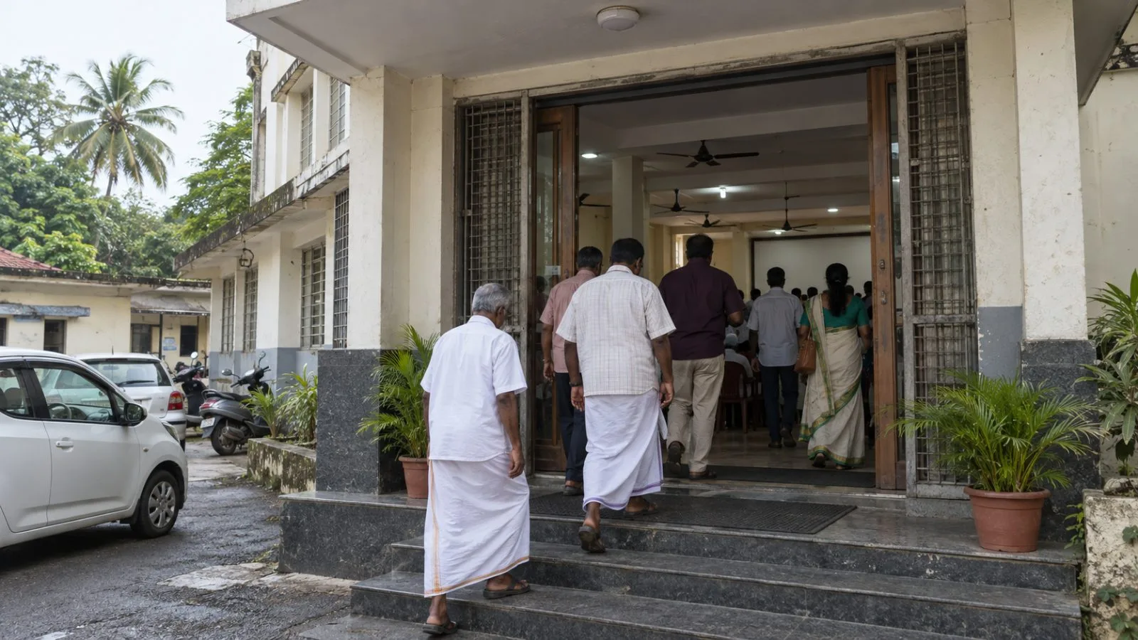 Attendees enter the Calicut City Service Cooperative Society in Kozhikode, Kerala. (AI-generated image / EconoTimes)