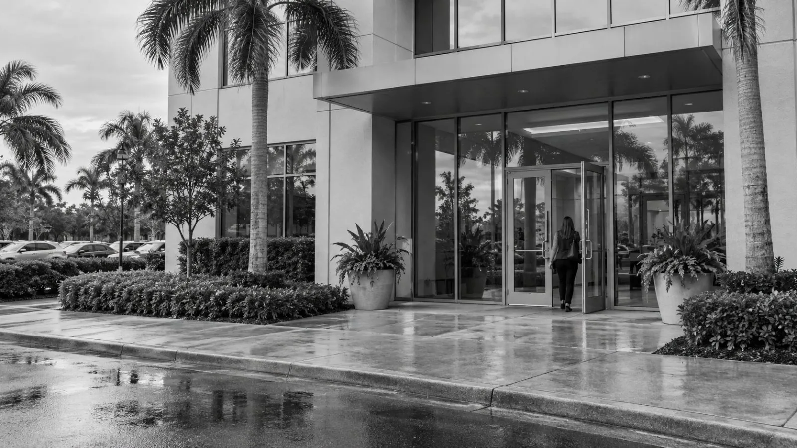 An employee enters a commercial office building on North Federal Highway in Boca Raton, Florida. (AI-generated image / EconoTimes)