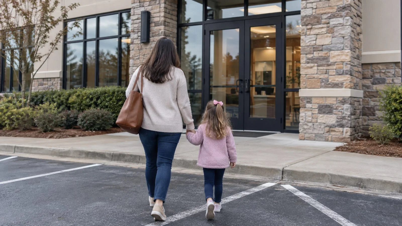 A parent and child approach a dental clinic entrance in Milton, Georgia. (AI-generated image / EconoTimes)