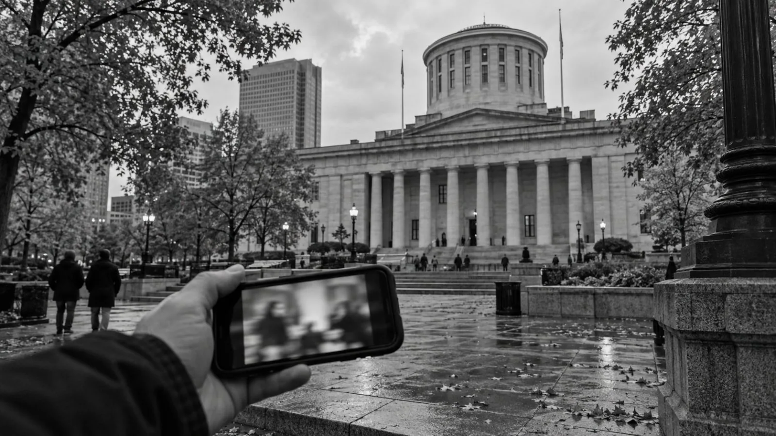 A passerby watches a campaign video on a phone outside the Ohio Statehouse in Columbus. (AI-generated image / EconoTimes)