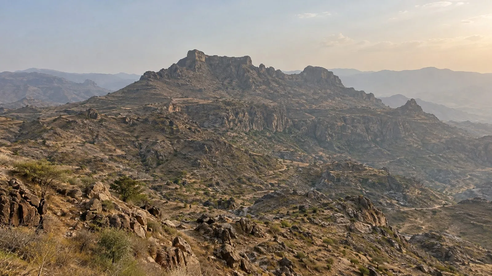 A rocky ridgeline rises above Jabal Habashi district in Yemen’s Taiz Governorate. (AI-generated image / EconoTimes)