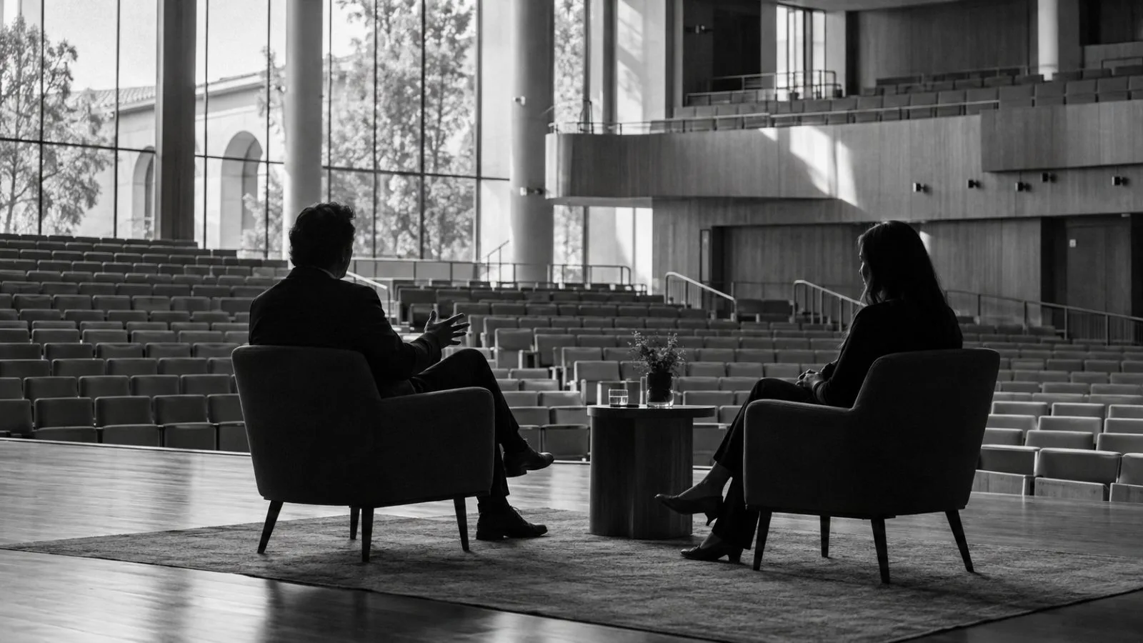 Two interview chairs sit onstage at Stanford Graduate School of Business in Stanford, California. (AI-generated image / EconoTimes)