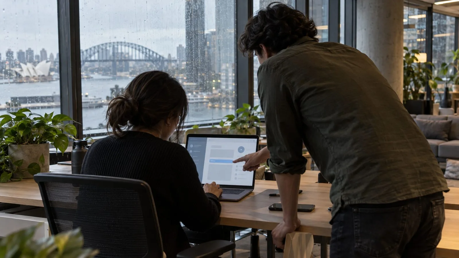 An employee reviews an AI agent’s access settings on a laptop in an office in Sydney, Australia. / EconoTimes.ai