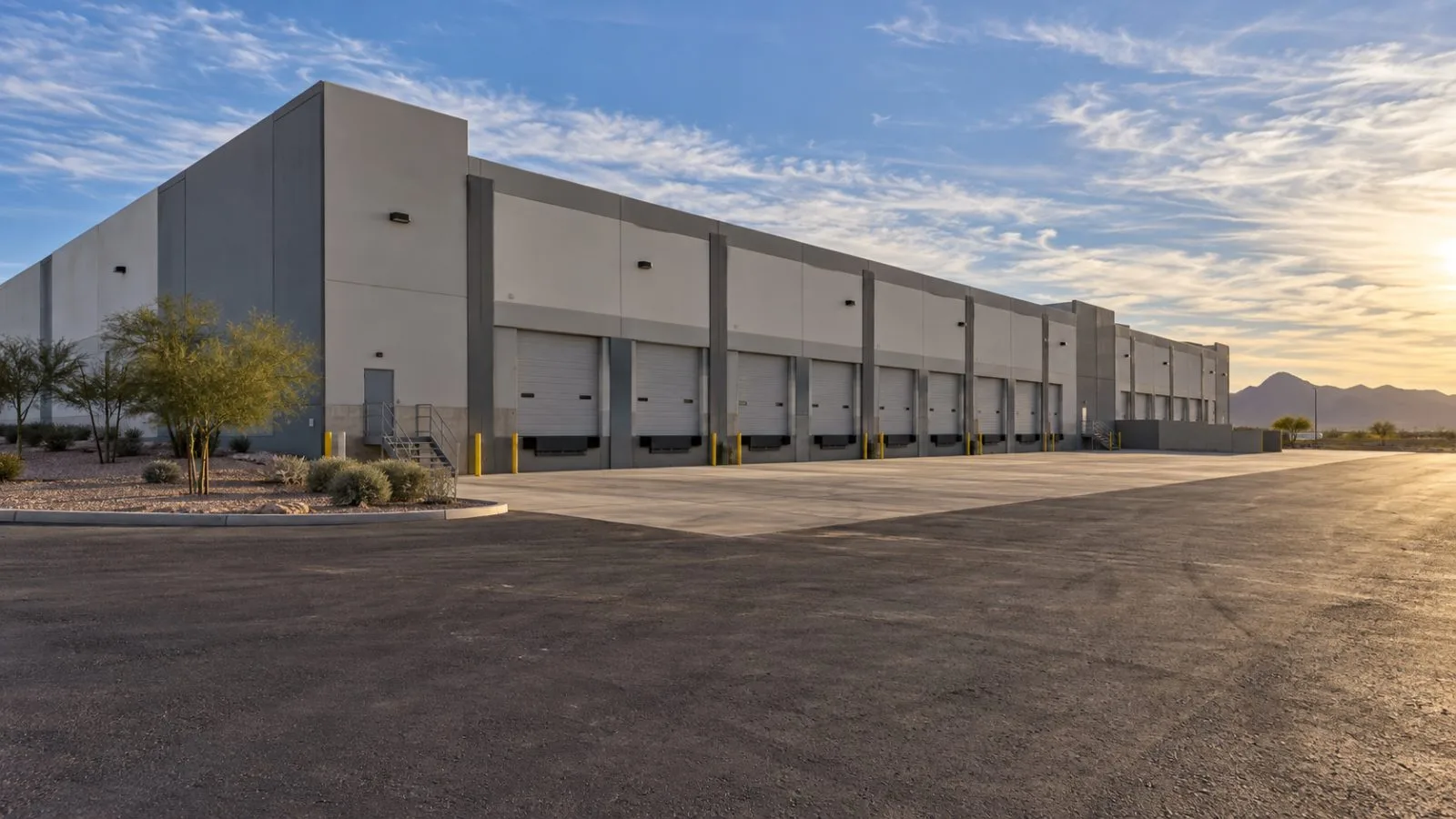 A large industrial building stands in Goodyear, Arizona, beneath a clear desert sky. (AI-generated image / EconoTimes)