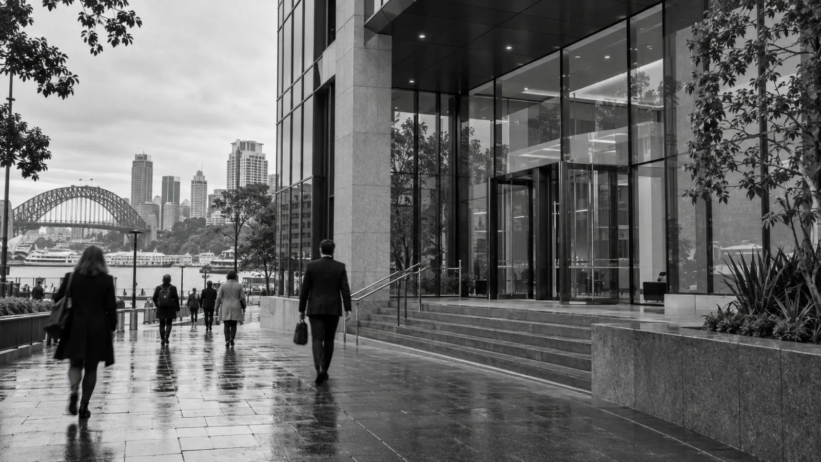 Office workers pass a building entrance in Sydney, Australia, on an overcast morning. (AI-generated image / EconoTimes)