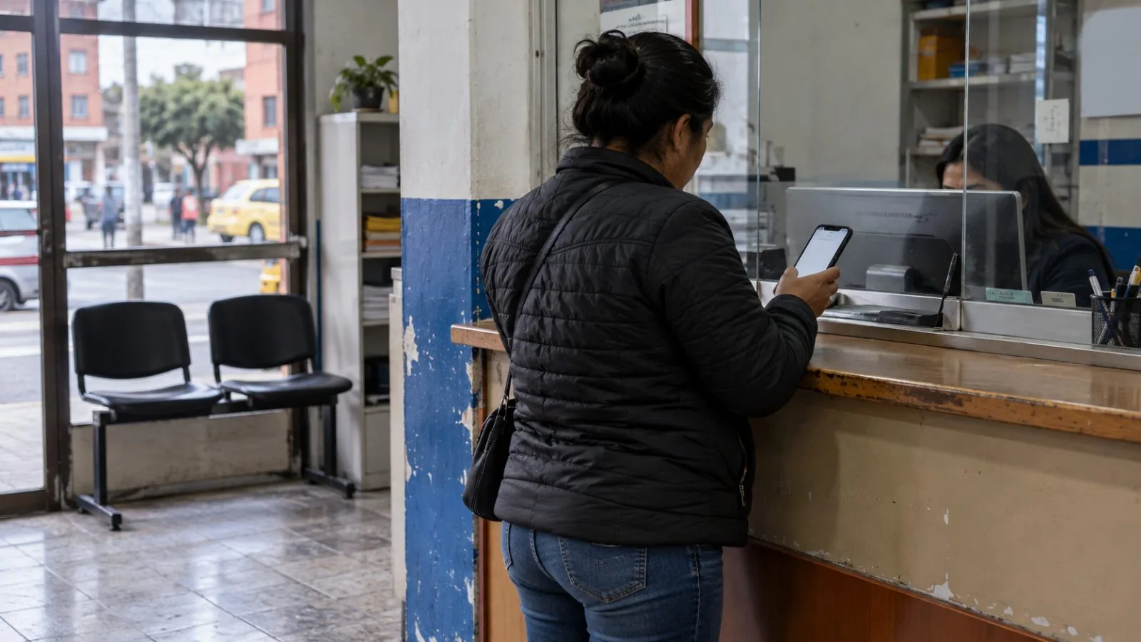 A customer checks a phone at a remittance counter in Bogotá, Colombia. (AI-generated image / EconoTimes)