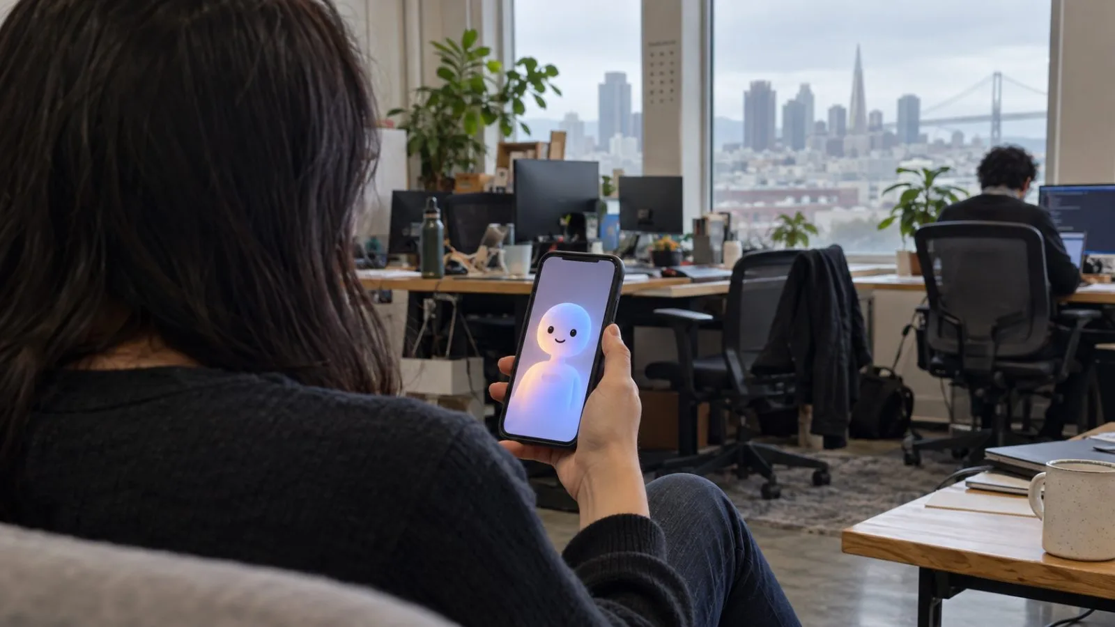 A phone displays an animated companion inside a San Francisco workspace. (AI-generated image / EconoTimes)