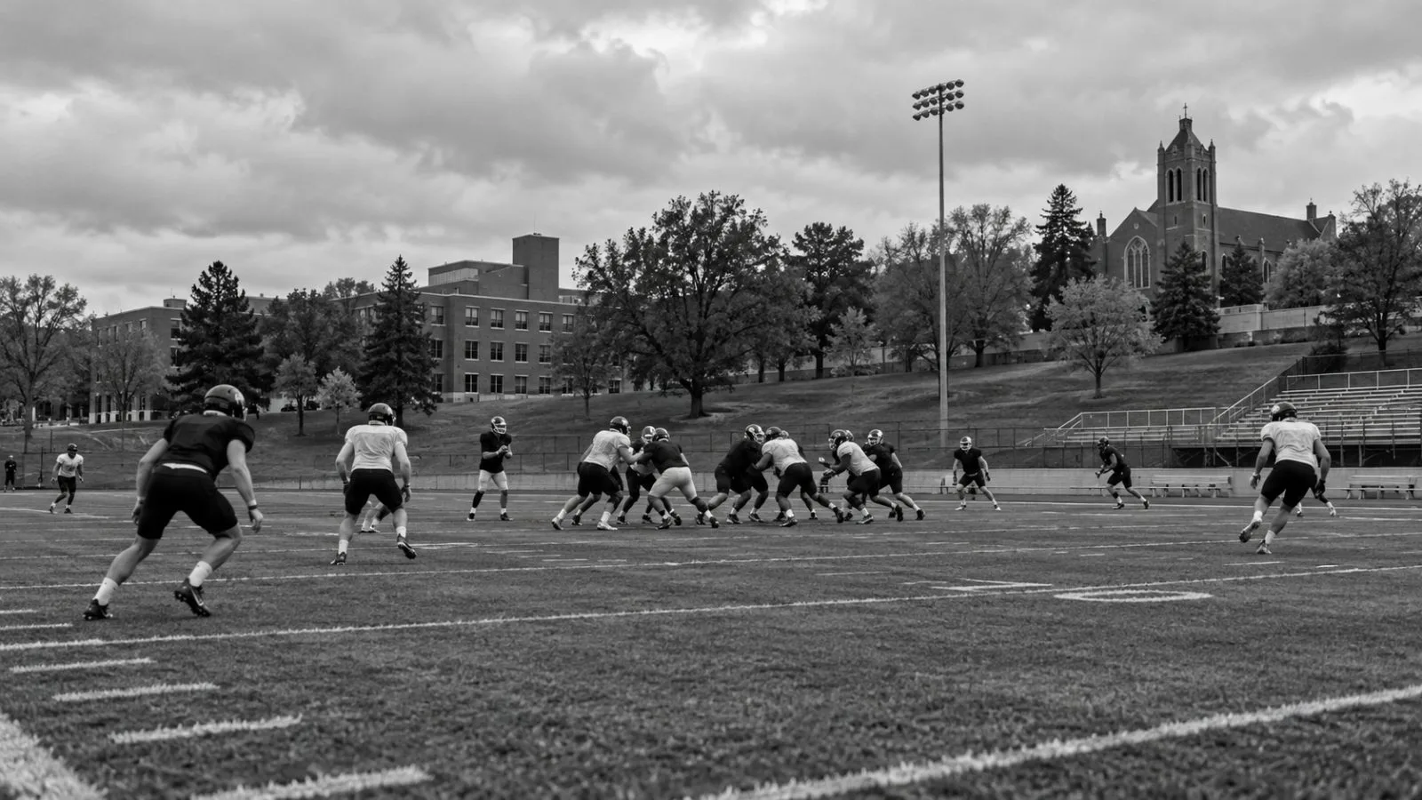 Players run a drill on the football field at Mount Mercy University in Cedar Rapids, Iowa. (AI-generated image / EconoTimes)