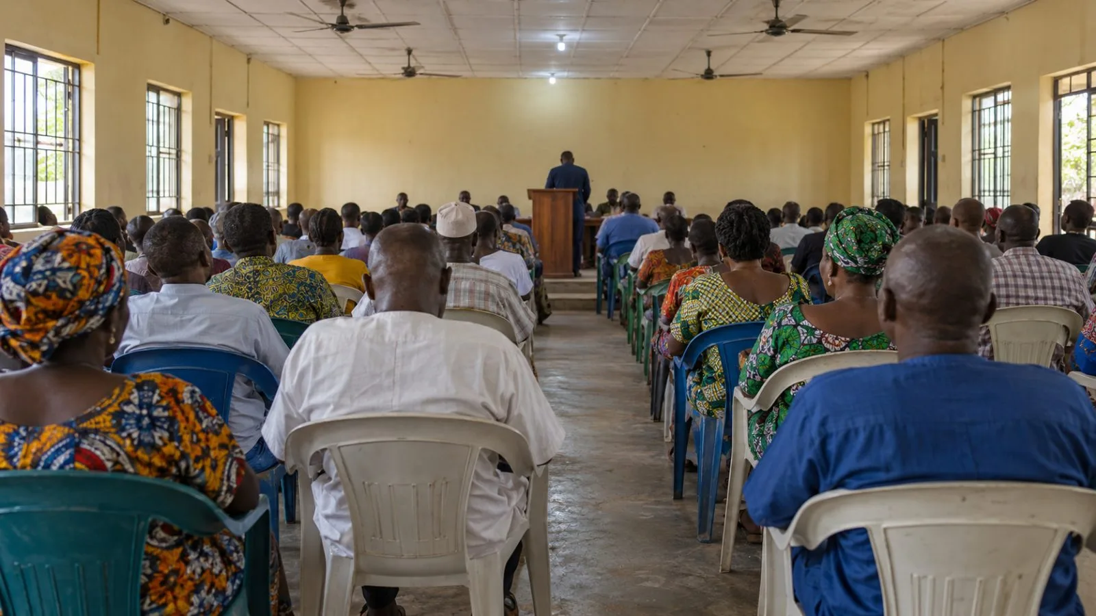 Attendees face a lectern during a town hall gathering in Uyo, Nigeria. (AI-generated image / EconoTimes)