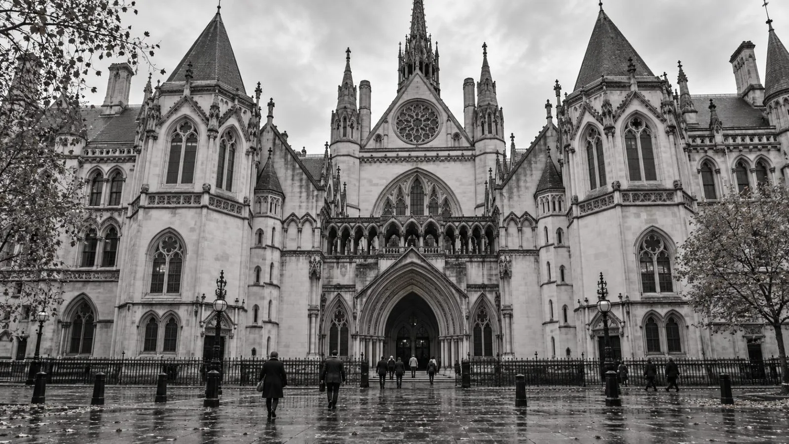 The Royal Courts of Justice stands on the Strand in London beneath a grey autumn sky. / EconoTimes.ai