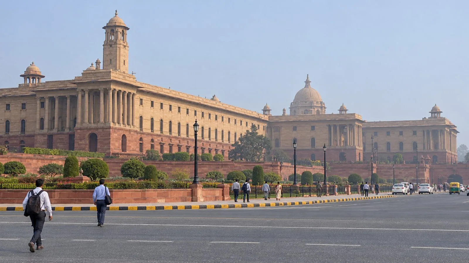 Pedestrians pass North Block, home to India's finance ministry, in New Delhi. / EconoTimes.ai
