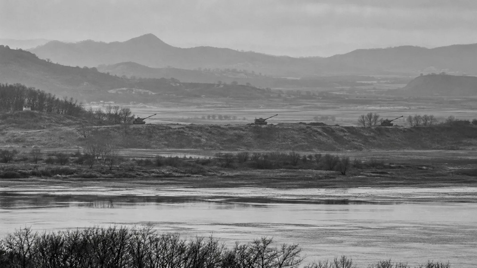North Korean howitzers are seen across the border from Aegibong Observatory in Gimpo, South Korea. (AI-generated image / EconoTimes)