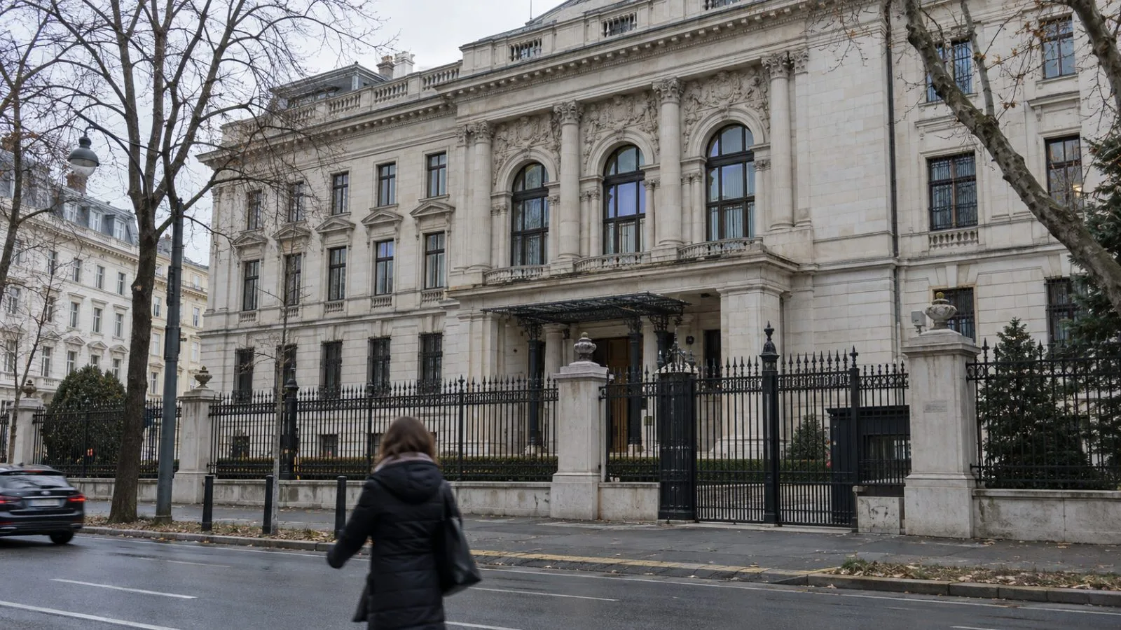 The Russian Embassy stands behind iron railings on a Vienna street under overcast skies. (AI-generated image / EconoTimes)