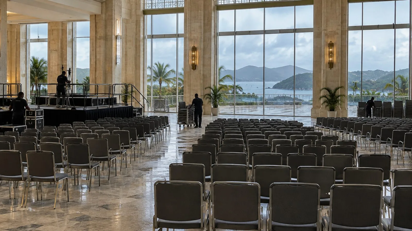 Staff arrange chairs inside the Commonwealth summit venue in St. John's, Antigua and Barbuda (AI-generated image / EconoTimes)