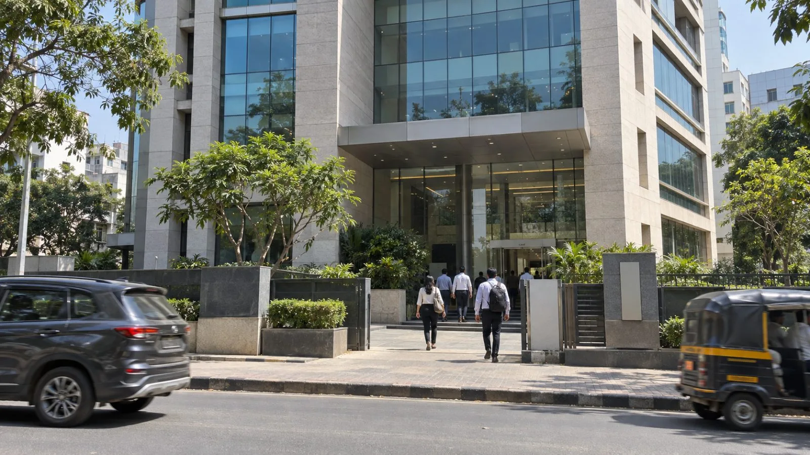 Employees pass a security gate at a Persistent Systems office in Pune, India. / EconoTimes.ai