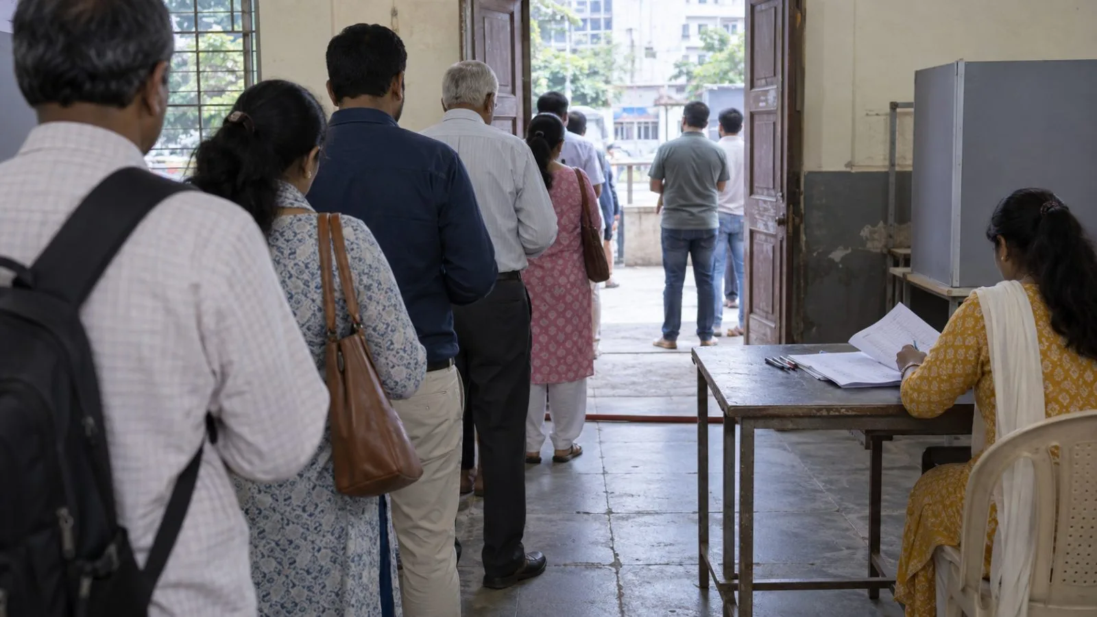 Voters queue outside a polling station in Pune during Maharashtra Legislative Council elections. (AI-generated image / EconoTimes)