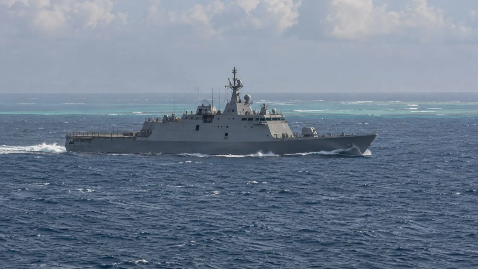 A littoral combat ship moves through open water near Sabina Shoal in the South China Sea (AI-generated image / EconoTimes)