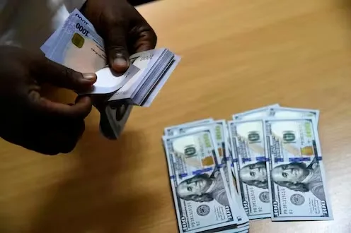 A man exchanges Nigeria's Naira for US dollars in Lagos in April 2021. Pius Utomi Ekpei/AFP via Getty Images