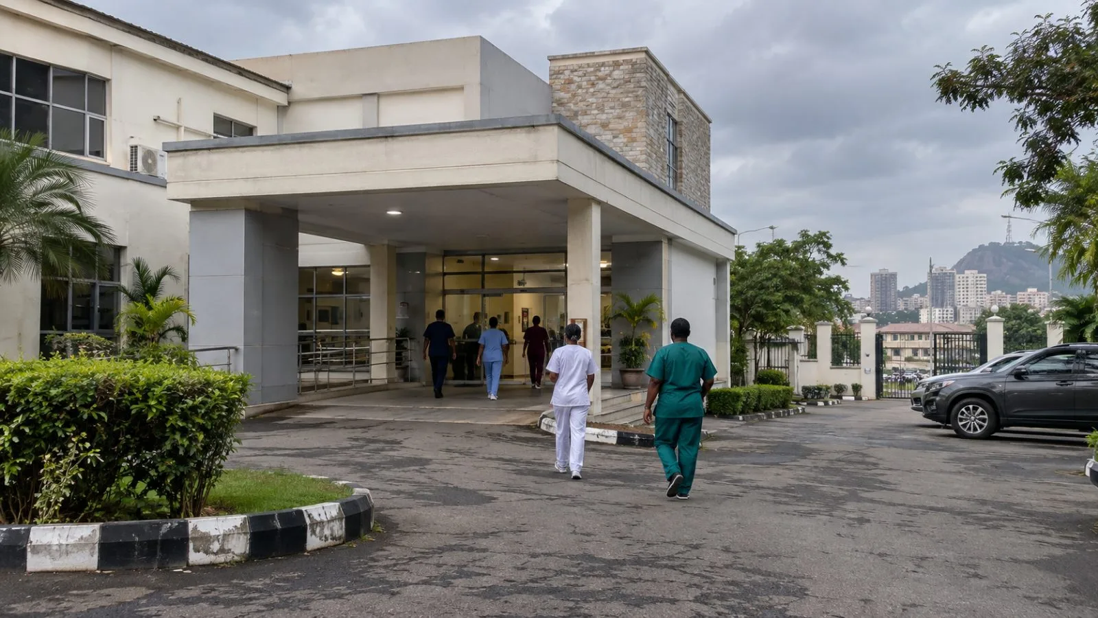 Health workers enter a private medical facility in Abuja, Nigeria. (AI-generated image / EconoTimes)