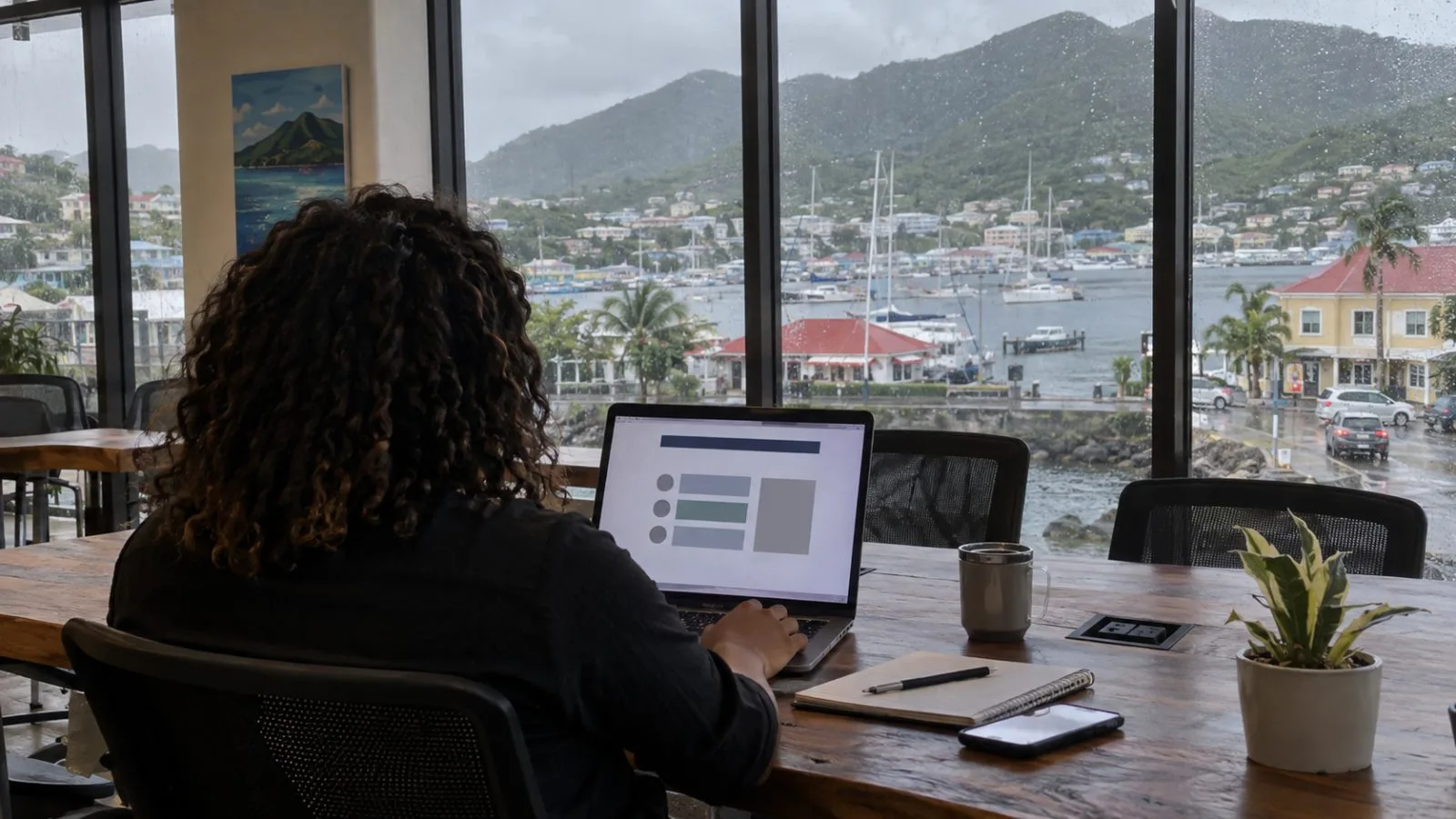 A participant reviews a laptop at a shared workspace in Road Town, Tortola. (AI-generated image / EconoTimes)
