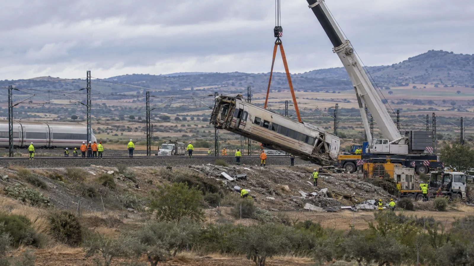 A crane lifts damaged train cars at the recovery site near Urda, Spain (AI-generated image / EconoTimes)