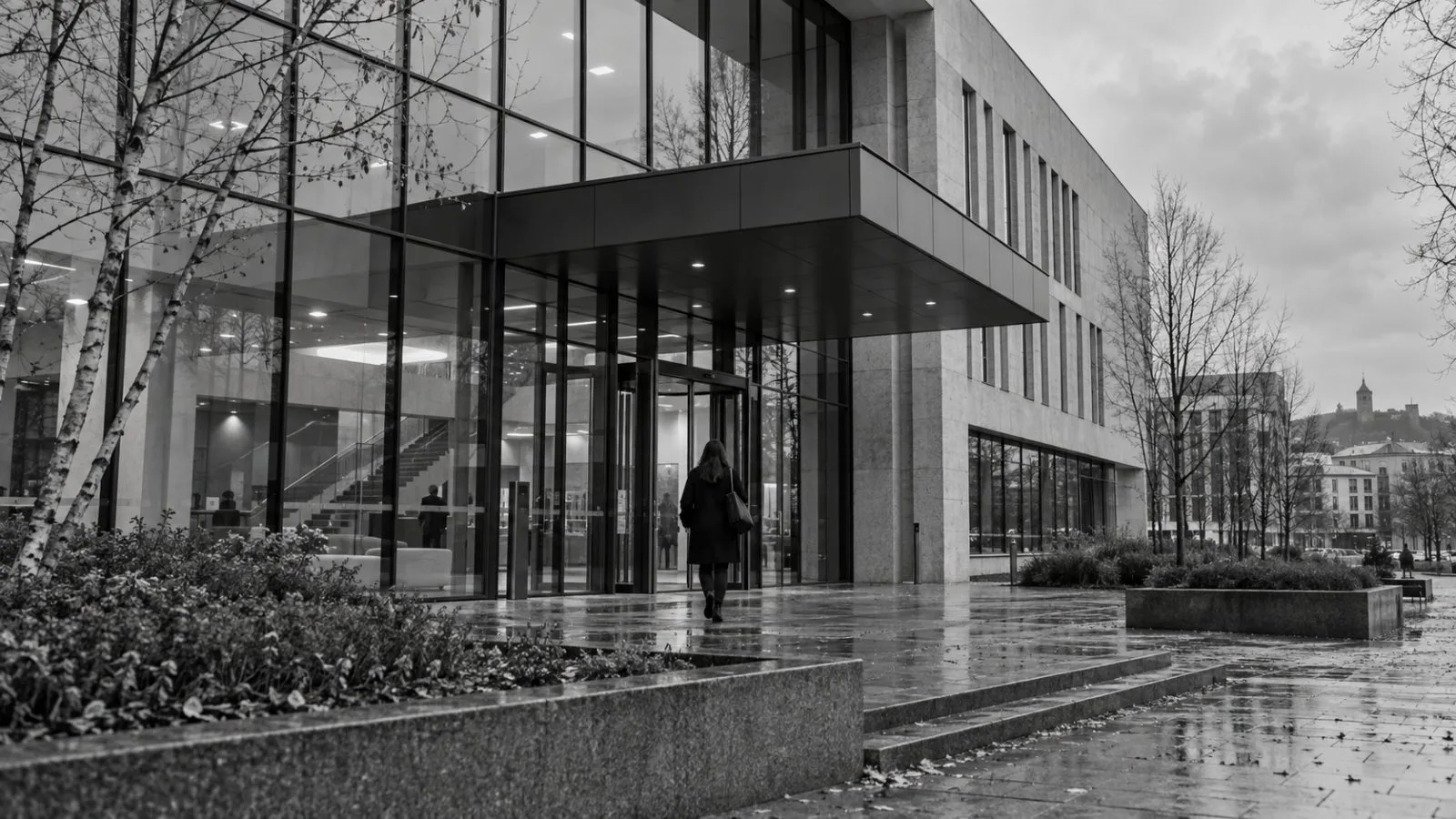 An anonymous figure enters the ISM University of Management and Economics building in Vilnius, Lithuania. (AI-generated image / EconoTimes)
