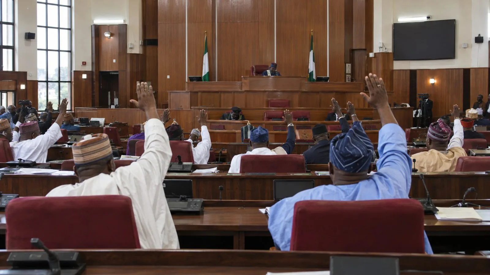 Lawmakers vote during a plenary session at the Ondo State House of Assembly in Akure, Nigeria. (AI-generated image / EconoTimes)