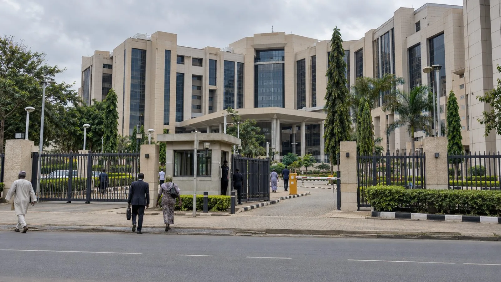 The Federal Ministry of Finance entrance stands behind a security gate in Abuja, Nigeria. (AI-generated image / EconoTimes)