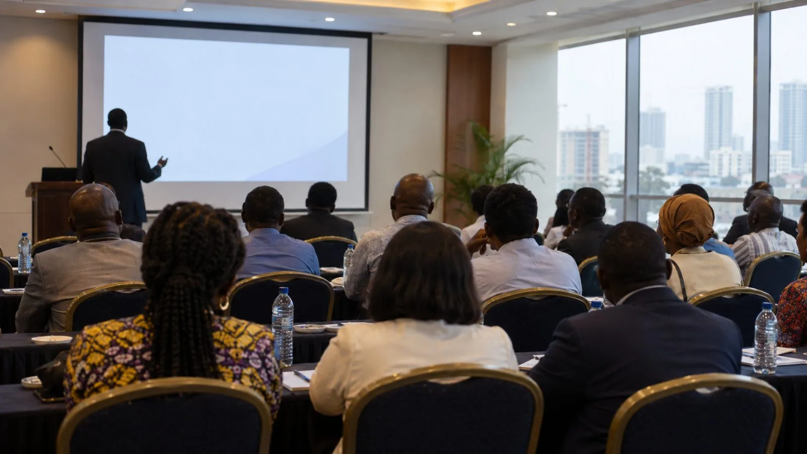 Attendees listen during a banking institute event in a Lagos conference hall. (AI-generated image / EconoTimes)