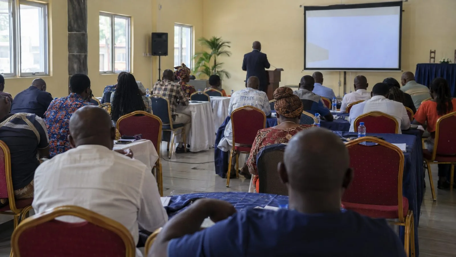 Attendees listen during a small-business conference in Yenagoa, Nigeria. (AI-generated image / EconoTimes)
