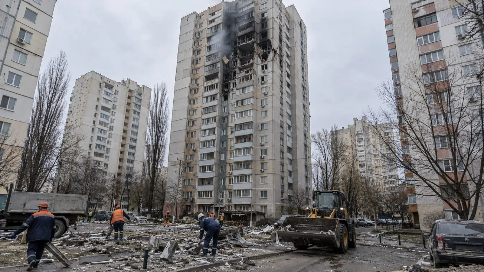 Workers clear debris outside a damaged apartment tower in Kyiv's Sviatoshynskyi district. (AI-generated image / EconoTimes)