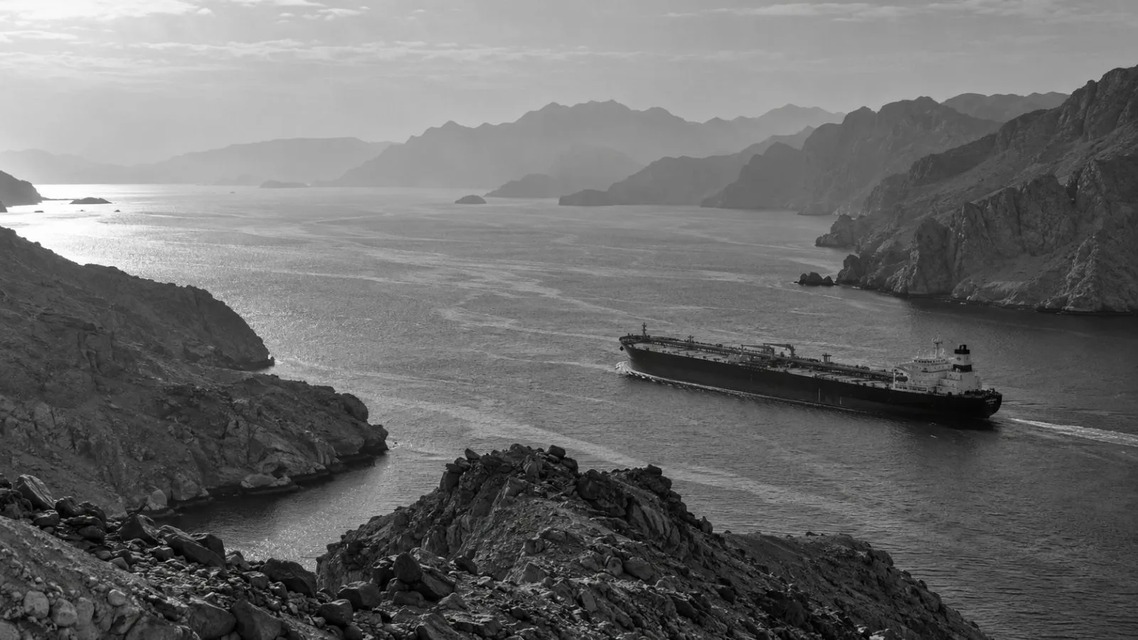 An oil tanker passes through the Strait of Hormuz off Musandam, Oman. (AI-generated image / EconoTimes)