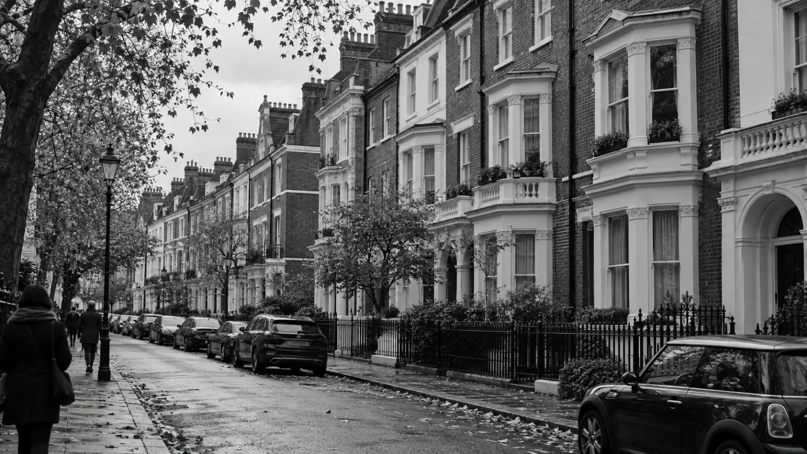 Apartment buildings line a residential street in London beneath an overcast autumn sky (AI-generated image / EconoTimes)