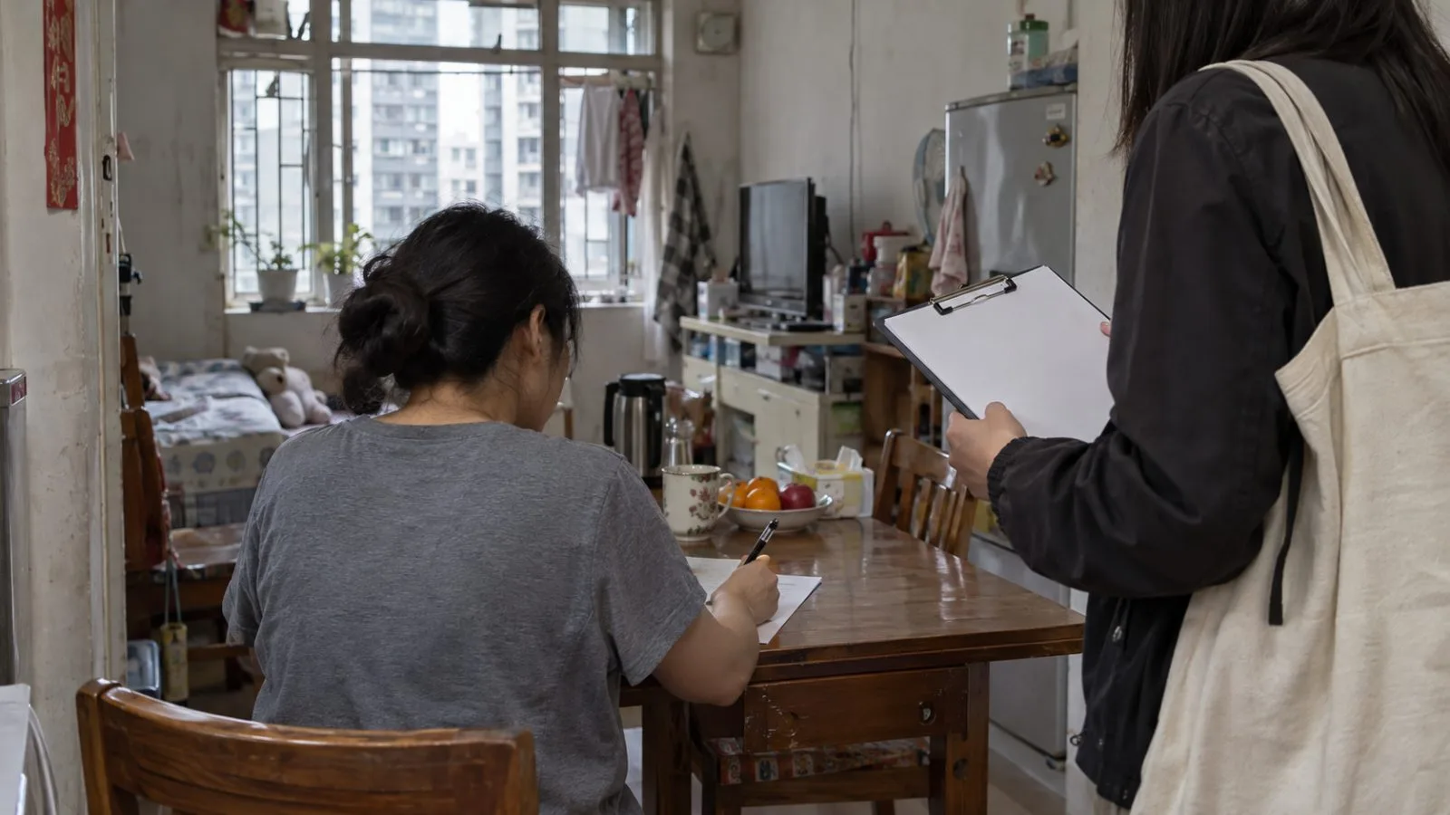 An interviewer holds a questionnaire as a resident responds inside a Hong Kong apartment. (AI-generated image / EconoTimes)