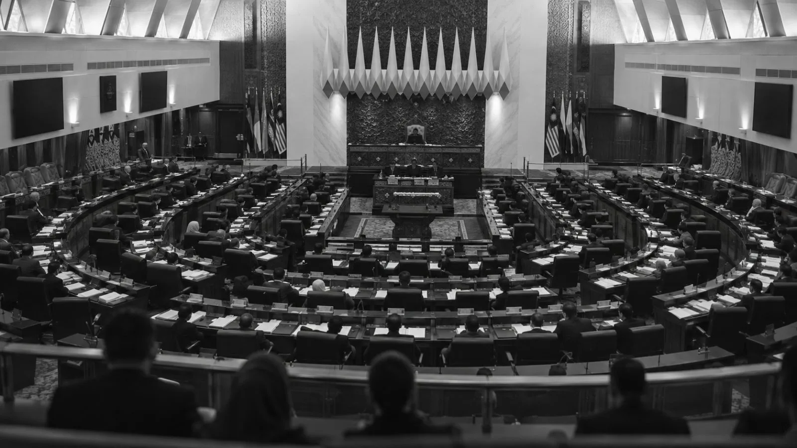 Lawmakers sit in Malaysia's Parliament chamber in Kuala Lumpur during an afternoon session. (AI-generated image / EconoTimes)