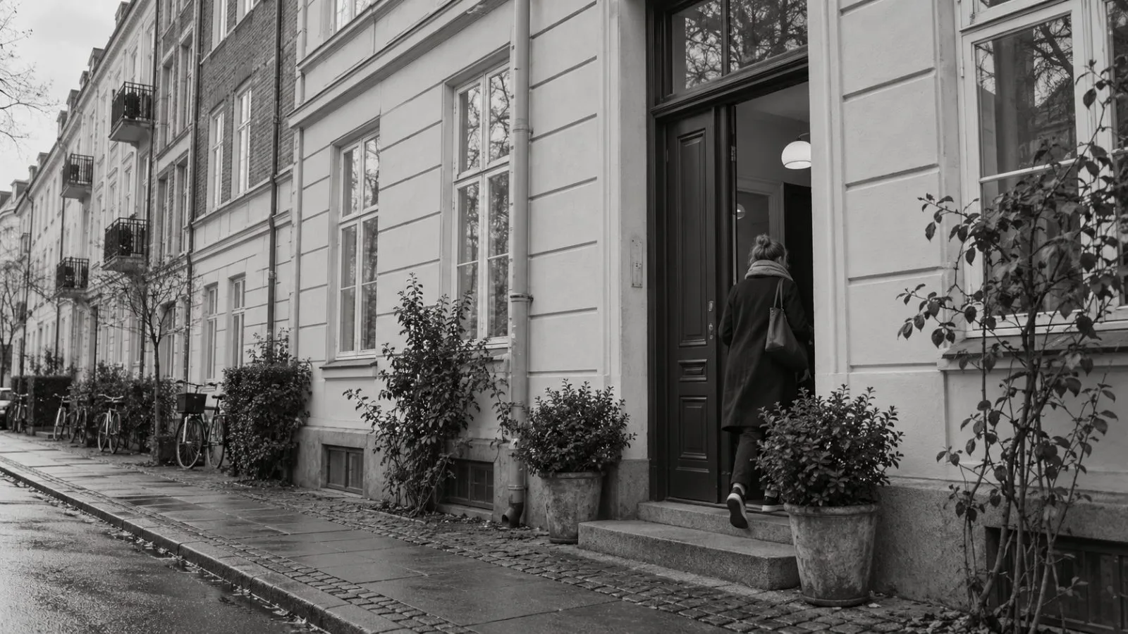 A tenant enters an apartment building on a residential street in Copenhagen, Denmark. (AI-generated image / EconoTimes)