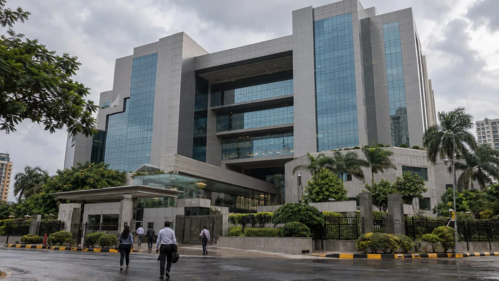 Employees enter the eMudhra Digital Campus in Bengaluru, India, beneath cloudy skies. / EconoTimes.ai