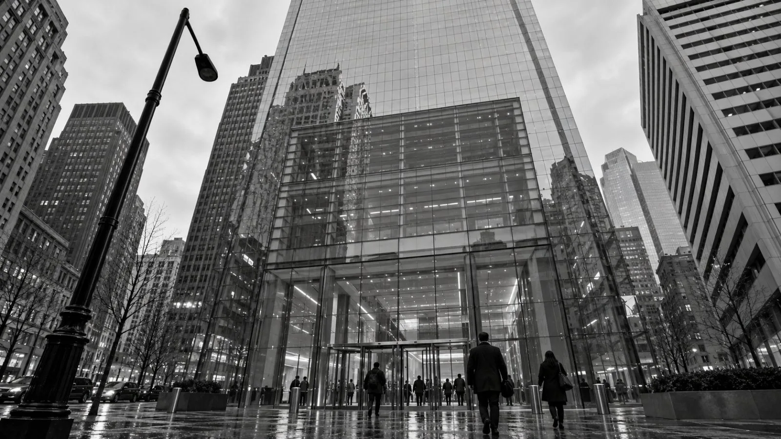 Pedestrians cross outside Comcast Center in Philadelphia on an overcast morning. / EconoTimes.ai