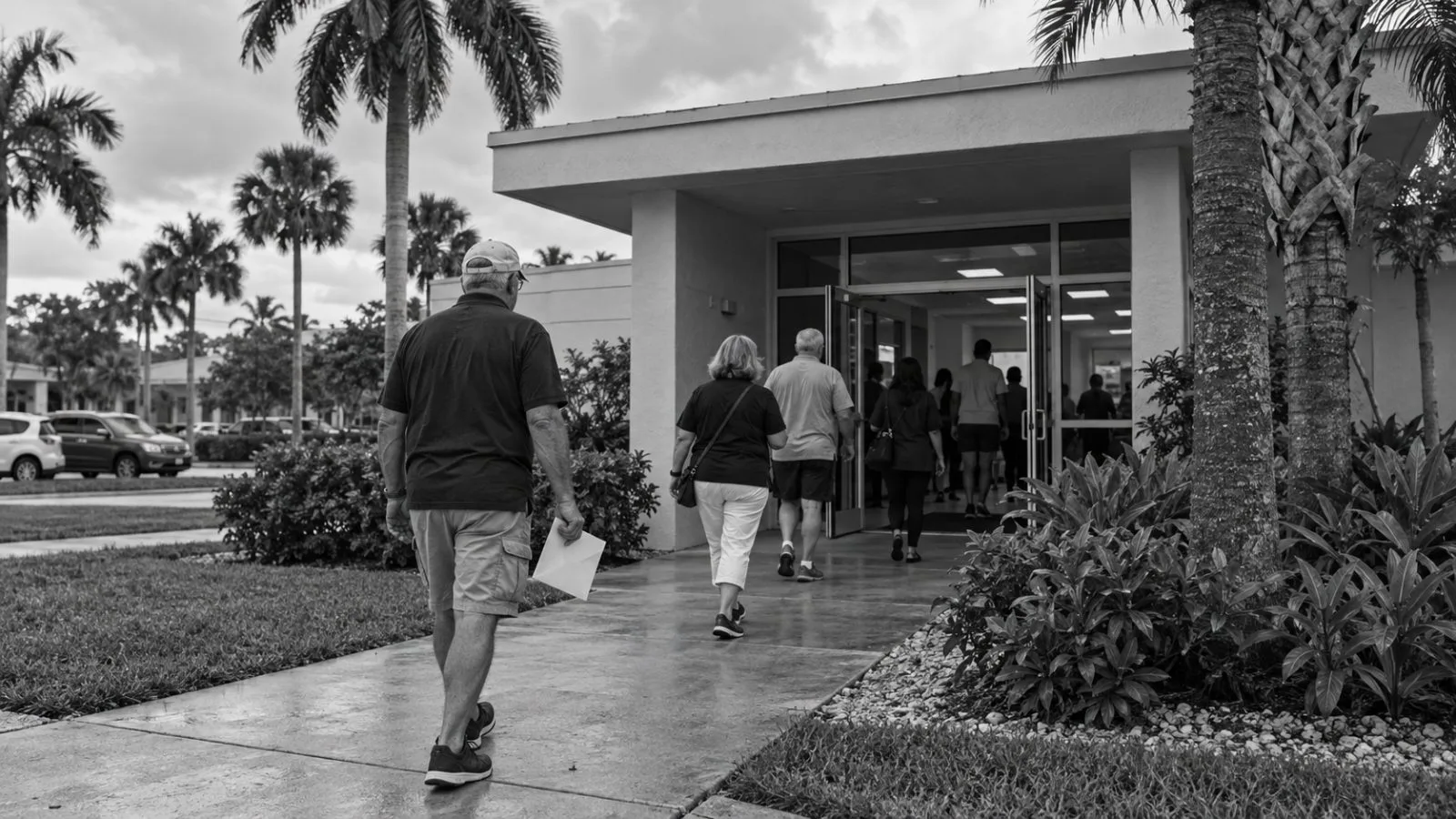 Voters enter an early voting site in West Palm Beach, Florida, on an overcast morning (AI-generated image / EconoTimes)