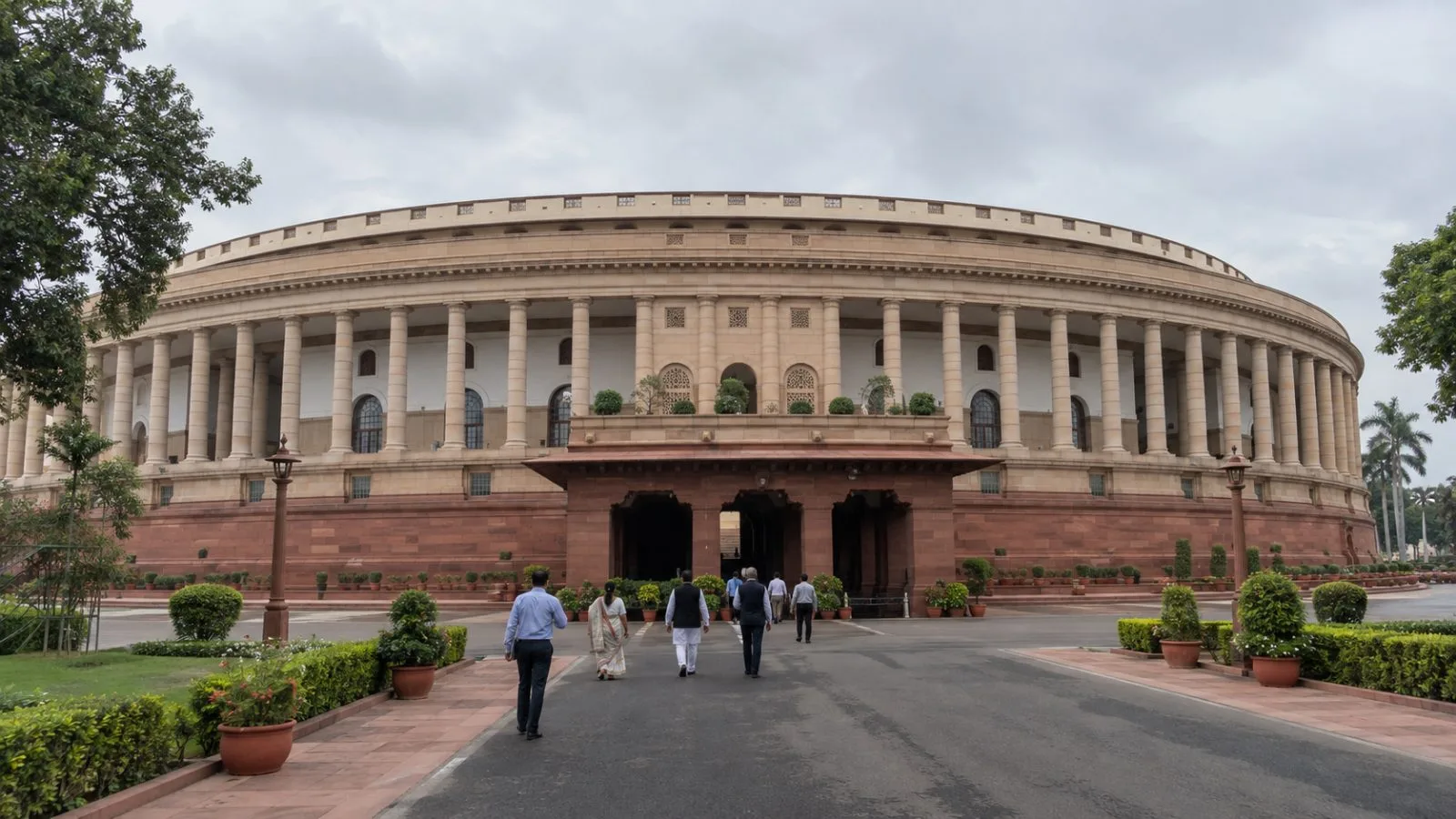 Visitors walk toward India's Parliament House in New Delhi on an overcast morning. (AI-generated image / EconoTimes)