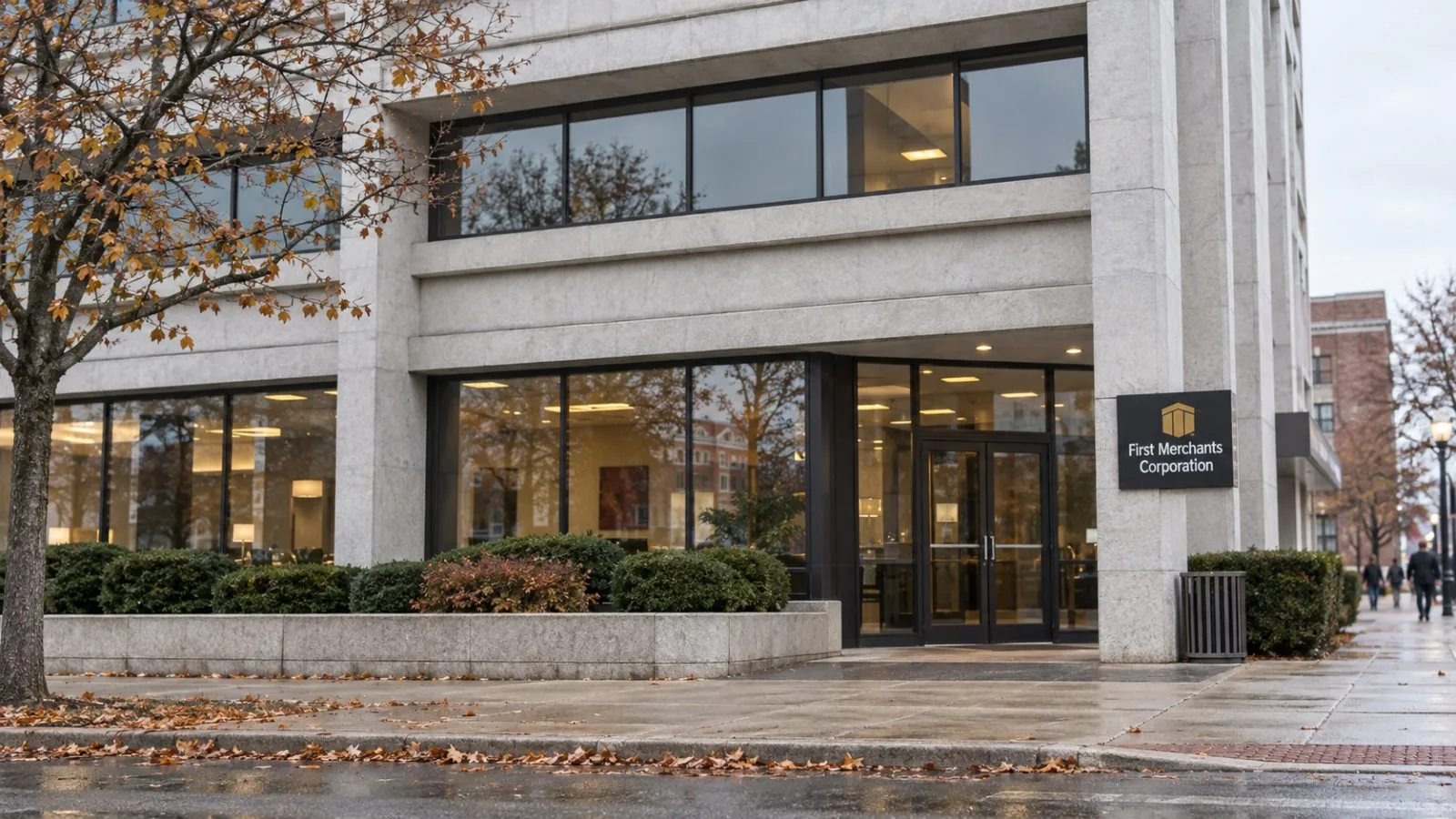 A pedestrian passes a five-story bank office on East Jackson Street in Muncie, Indiana. / EconoTimes.ai