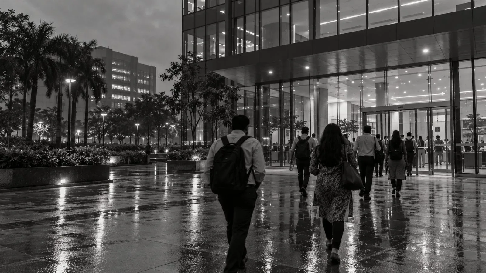 Workers enter an office campus in Navi Mumbai, India, after evening rain. (AI-generated image / EconoTimes)